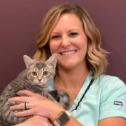 A smiling woman holding a cat