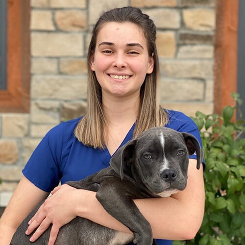 A woman holding a dog