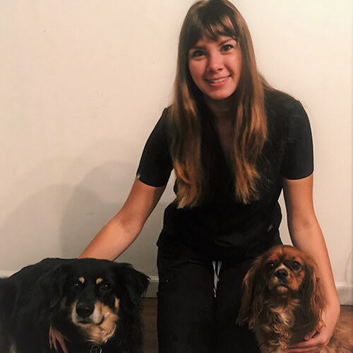 Justine A woman posing with a dog at each side of her