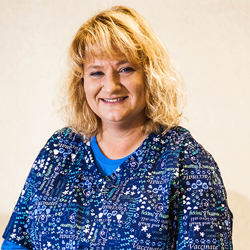 A woman posing for the camera and smiling