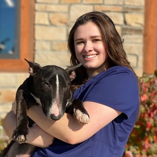 A woman holding a dog