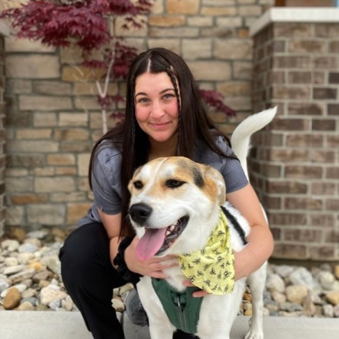 A woman holding a dog